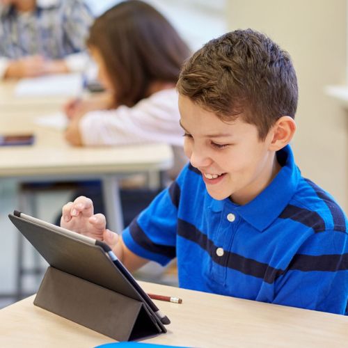 Child in class using tablet